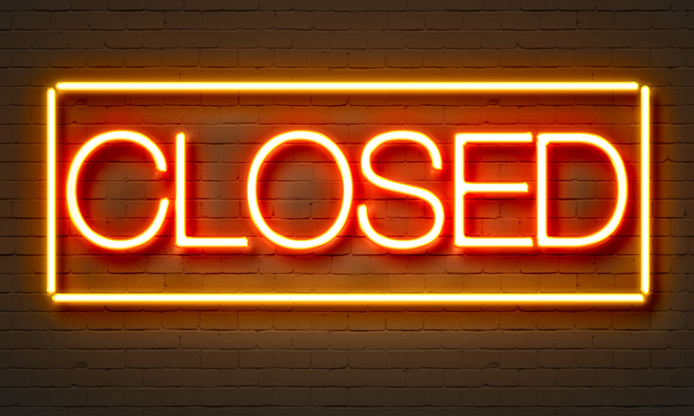 Closed Neon Sign on Brick Wall